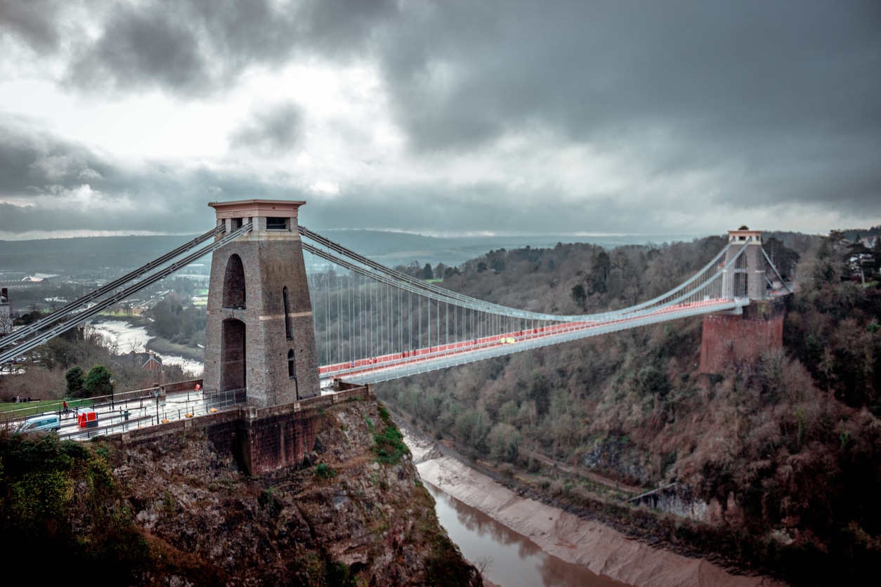 Mesmerizing shot of Clifton Suspension Bridge over the Avon Gorge in a gloomy day, Bristol, UK